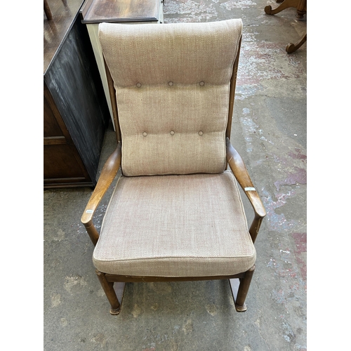 37 - A mid 20th century Parker Knoll PK1016-19 beech and fabric upholstered rocking chair