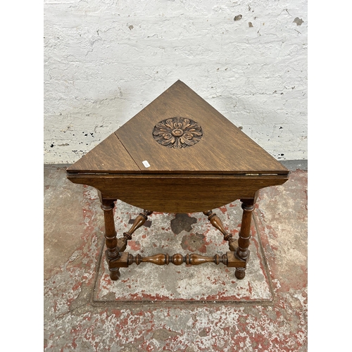 38C - A 17th century style carved oak triangular drop leaf side table - approx. 65cm high x 57cm wide x 50... 