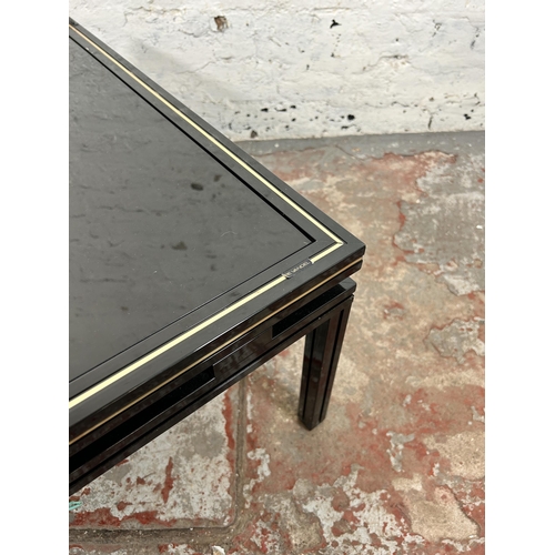 43 - A Pierre Vandel of Paris black lacquered metal and glass top coffee table - approx. 33cm high x 72cm... 