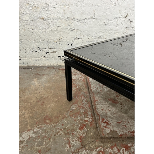 43 - A Pierre Vandel of Paris black lacquered metal and glass top coffee table - approx. 33cm high x 72cm... 