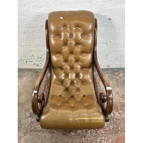 48 - A tan leather and mahogany Chesterfield slipper armchair