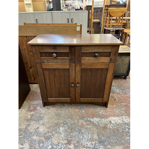 49 - An oak sideboard - approx. 82cm high x 85cm wide x 41cm deep