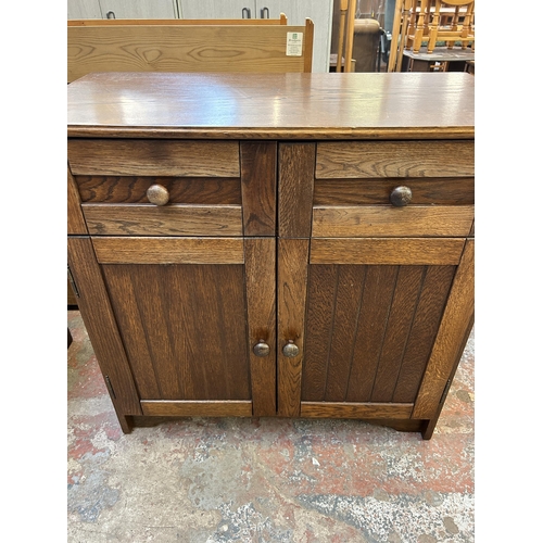 49 - An oak sideboard - approx. 82cm high x 85cm wide x 41cm deep