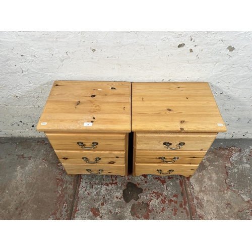 54 - A pair of pine bedside chests of drawers - approx. 58cm high x 43cm wide x 34cm deep