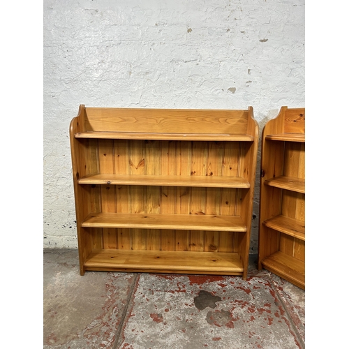 56 - Two pine four tier bookcases - largest approx. 93cm high x 91cm wide x 19cm deep