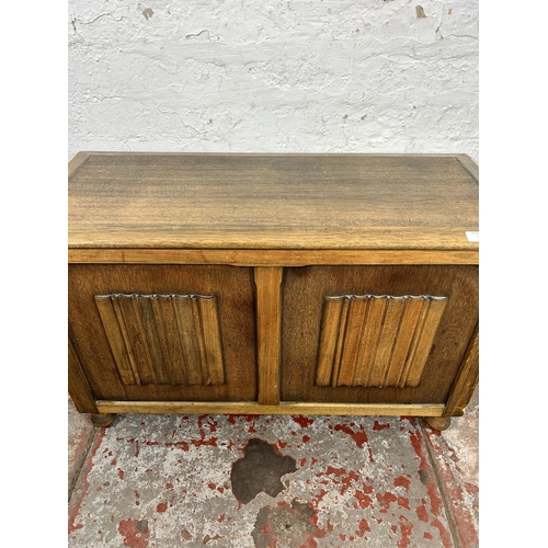 57 - A mid 20th century oak linenfold blanket box - approx. 52cm high x 82cm wide x 36cm deep