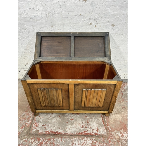 57 - A mid 20th century oak linenfold blanket box - approx. 52cm high x 82cm wide x 36cm deep