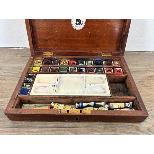 603 - An early 20th century Reeves mahogany cased artist travel box with gilt painted M.B initials to top ... 