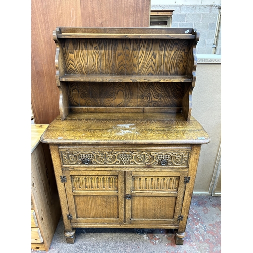 62 - A carved oak dresser - approx. 147cm high x 101cm wide x 46cm deep