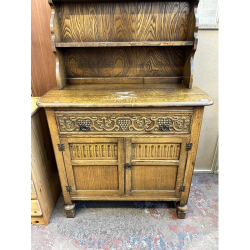 62 - A carved oak dresser - approx. 147cm high x 101cm wide x 46cm deep