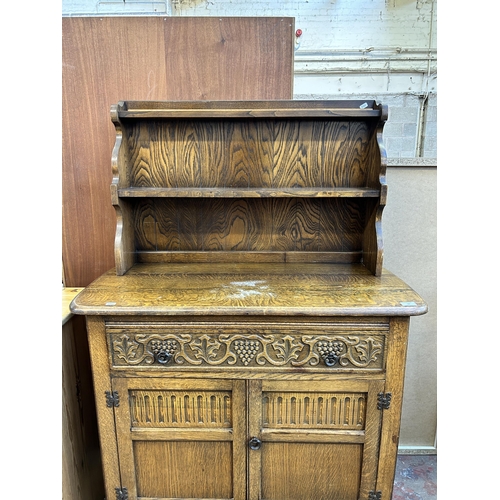 62 - A carved oak dresser - approx. 147cm high x 101cm wide x 46cm deep