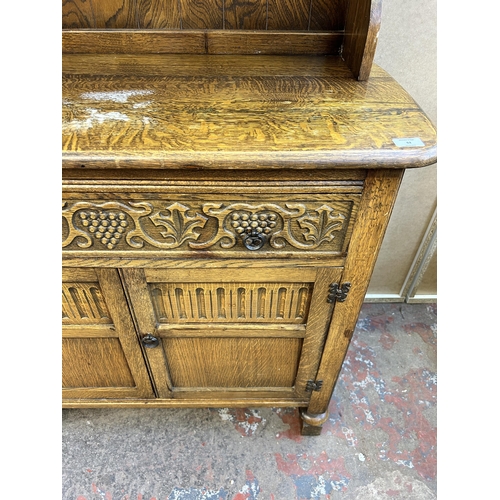 62 - A carved oak dresser - approx. 147cm high x 101cm wide x 46cm deep