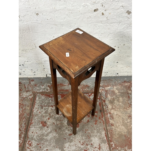 70 - An Arts & Crafts walnut two tier jardinière stand - approx. 83cm high x 24cm wide x 24cm deep