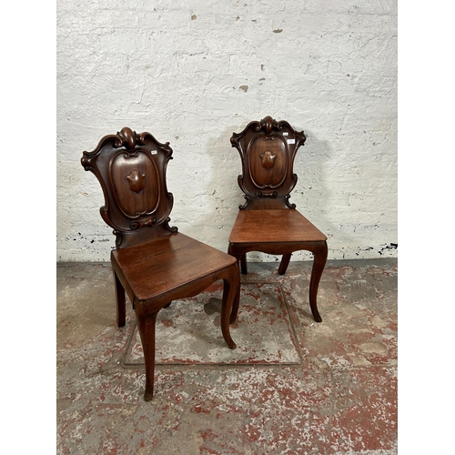 73 - Two 19th century carved mahogany hall chairs - approx. 88cm high x 41cm wide x 38cm deep