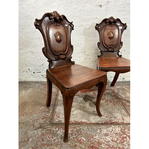 73 - Two 19th century carved mahogany hall chairs - approx. 88cm high x 41cm wide x 38cm deep