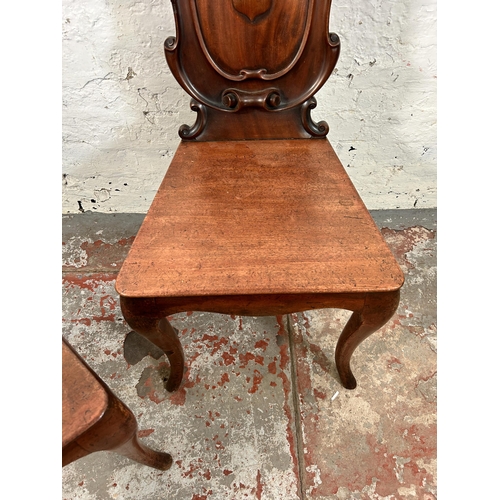 73 - Two 19th century carved mahogany hall chairs - approx. 88cm high x 41cm wide x 38cm deep