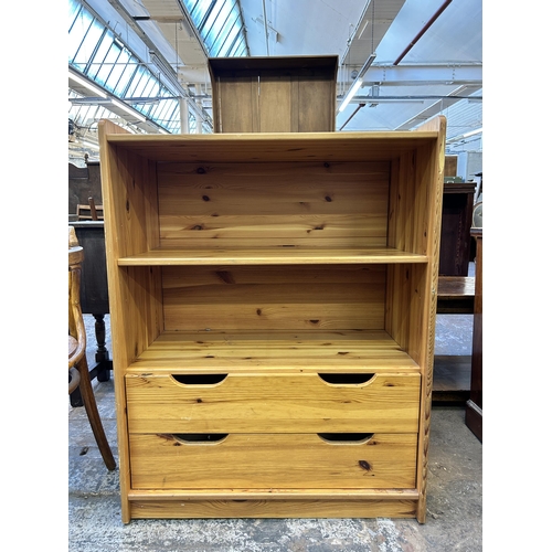 75 - A pine two tier bookcase with two lower drawers - approx. 103cm high x 79cm wide x 42cm deep