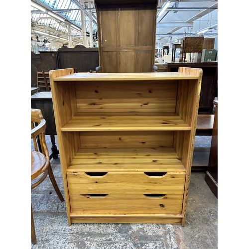 75 - A pine two tier bookcase with two lower drawers - approx. 103cm high x 79cm wide x 42cm deep