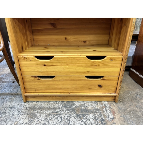 75 - A pine two tier bookcase with two lower drawers - approx. 103cm high x 79cm wide x 42cm deep