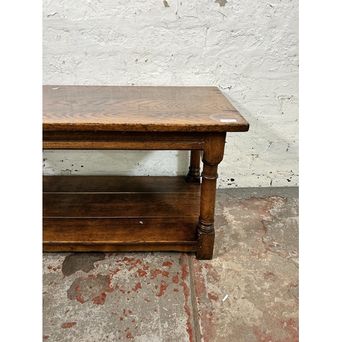 82 - A Titchmarsh & Goodwin style oak rectangular two tier coffee table on turned supports - approx. 48cm... 