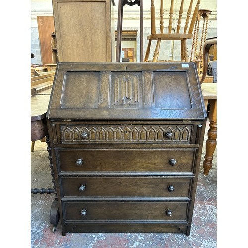 86 - A carved oak linenfold bureau - approx. 99cm high x 76cm wide x 46cm deep