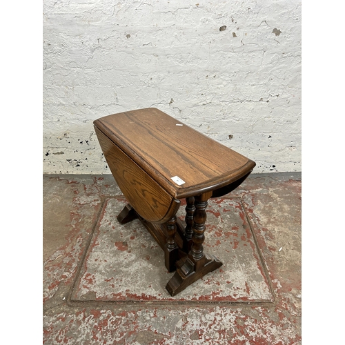 87 - An oak drop leaf gate leg oval side table - approx. 51cm high x 62cm wide x 75cm long