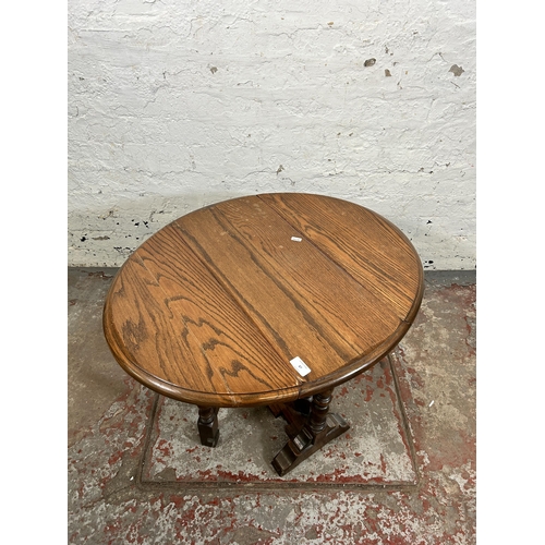 87 - An oak drop leaf gate leg oval side table - approx. 51cm high x 62cm wide x 75cm long