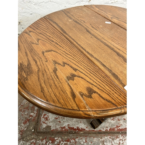 87 - An oak drop leaf gate leg oval side table - approx. 51cm high x 62cm wide x 75cm long