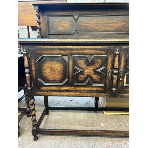 90 - An early 20th century geometric carved oak sideboard on barley twist supports - approx. 129cm high x... 