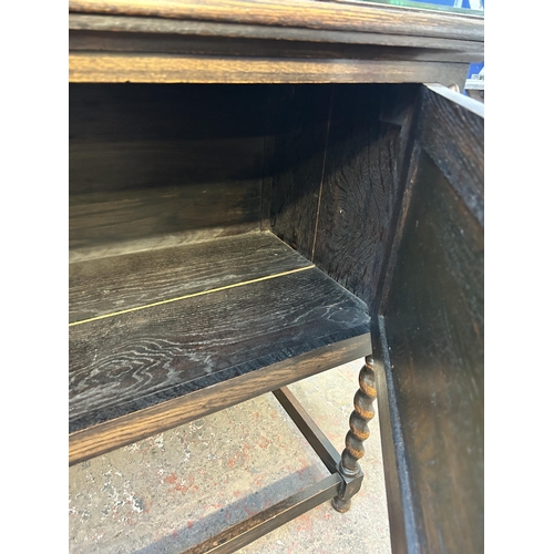 90 - An early 20th century geometric carved oak sideboard on barley twist supports - approx. 129cm high x... 