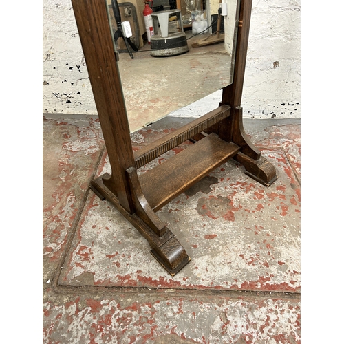 93 - An early/mid 20th century oak framed cheval mirror - approx. 147cm high x 51cm wide x 43cm deep