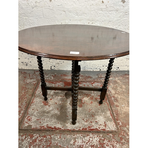 146 - An early 20th century oak tilt top occasional table on bobbin turned supports - approx. 61cm high x ... 