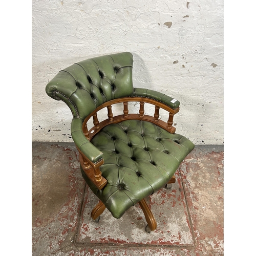 152 - A green leather and beech Chesterfield captain's swivel desk chair - approx. 87cm high x 64cm wide x... 