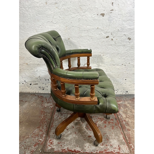 152 - A green leather and beech Chesterfield captain's swivel desk chair - approx. 87cm high x 64cm wide x... 