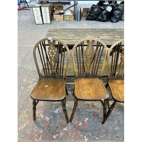 179 - Five beech wheelback dining chairs