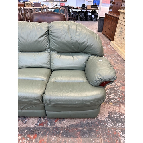 185 - A green leather three seater sofa