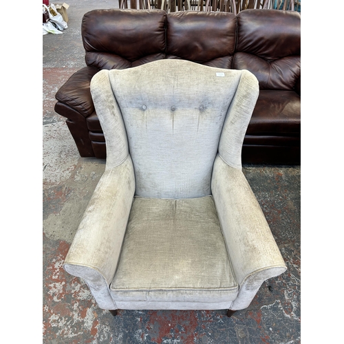 185A - A Laura Ashley silver fabric upholstered wingback armchair on turned mahogany supports - approx. 102... 