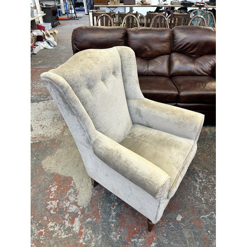 185A - A Laura Ashley silver fabric upholstered wingback armchair on turned mahogany supports - approx. 102... 