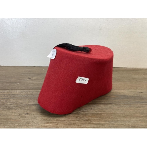 497 - A vintage red fez with black tasselled top