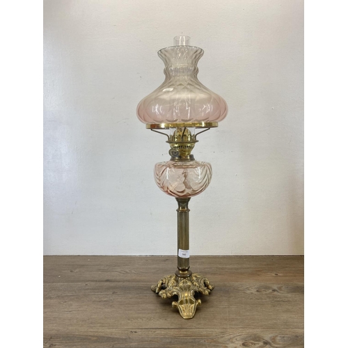 542 - A Victorian Duplex brass oil lamp with pink glass reservoir and shade - approx. 66cm high