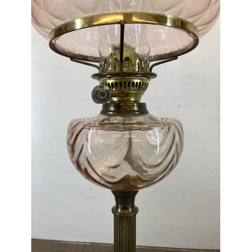 542 - A Victorian Duplex brass oil lamp with pink glass reservoir and shade - approx. 66cm high