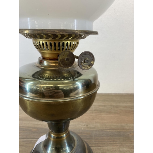 547 - A vintage brass oil lamp with opaline glass shade