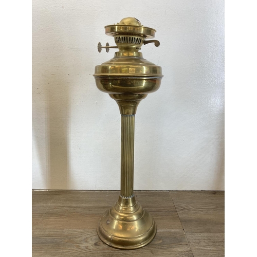 562 - Three brass oil lamps - largest approx. 48cm high