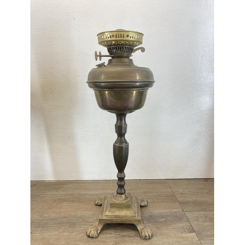 562 - Three brass oil lamps - largest approx. 48cm high