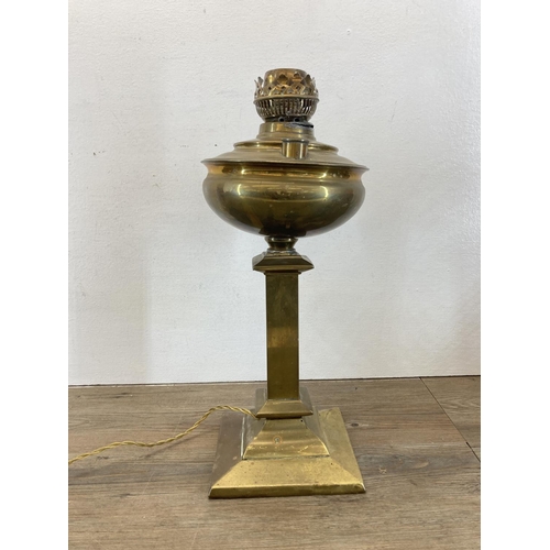 562 - Three brass oil lamps - largest approx. 48cm high