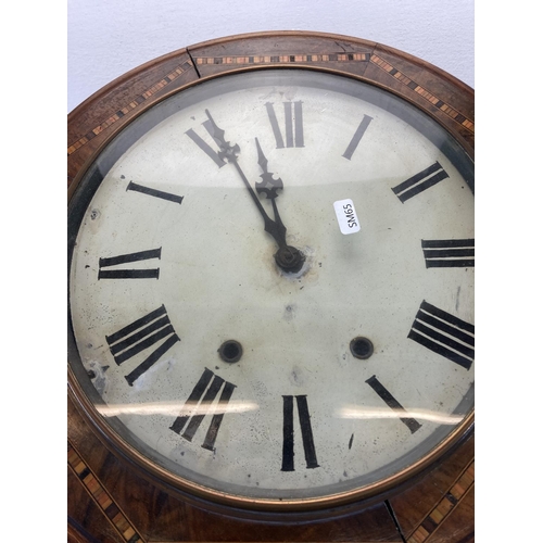 563 - A Victorian inlaid walnut chiming wall clock with white painted face and black Roman numerals