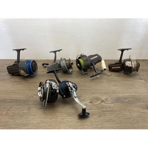 573 - Five vintage fishing reels to include three Daiwa etc.