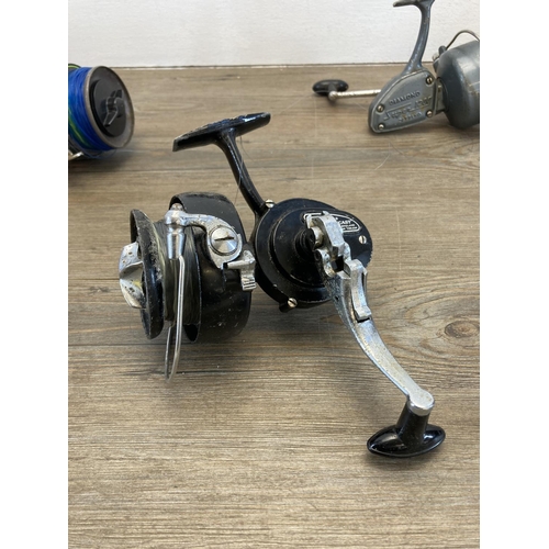 573 - Five vintage fishing reels to include three Daiwa etc.