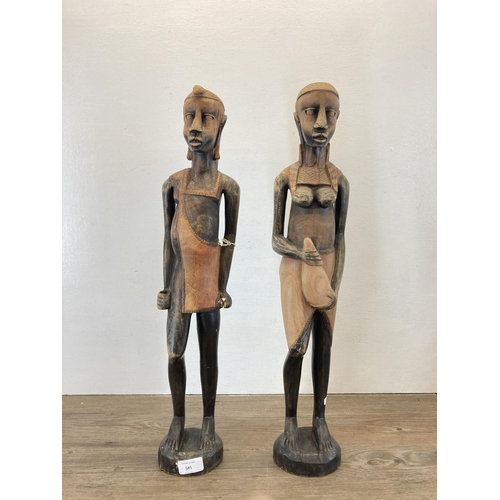 585 - A pair of African Tribal style carved hardwood figurines - approx. 60cm high