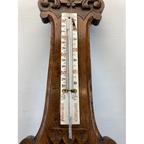 586 - A 19th century Nicholson & Cartner of Carlisle carved oak barometer - approx. 82cm high